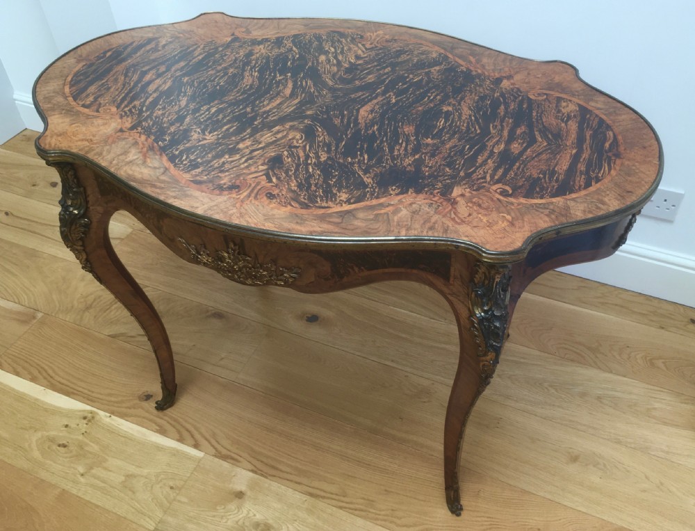 A Louis XV style shaped centre table featuring inlaid coromandel timber, curved cabriole legs, and gilded bronze mounts. View II