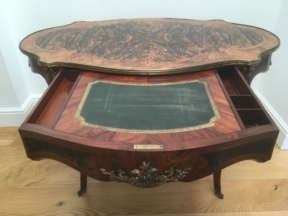A Louis XV style shaped centre table featuring inlaid coromandel timber, curved cabriole legs, and gilded bronze mounts. View III