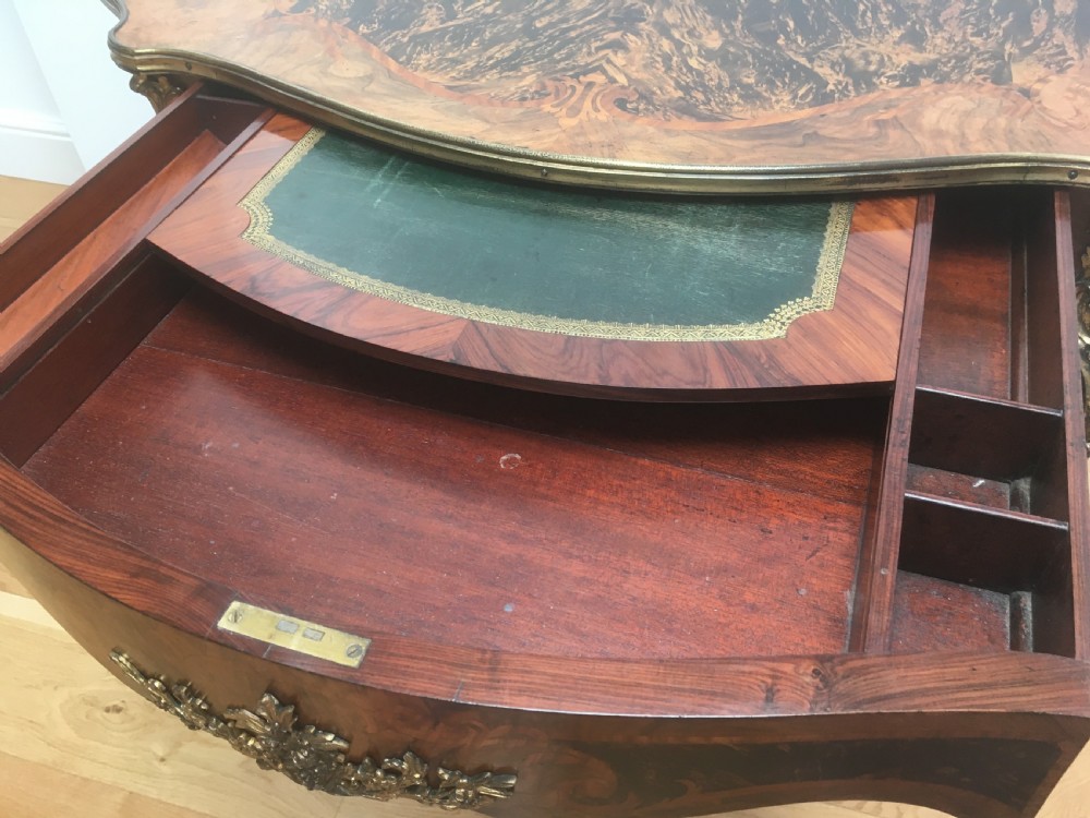A Louis XV style shaped centre table featuring inlaid coromandel timber, curved cabriole legs, and gilded bronze mounts. View IV