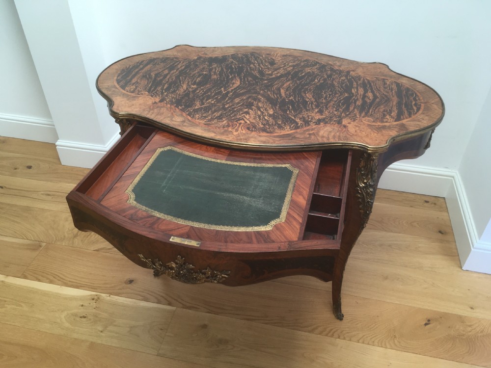 A Louis XV style shaped centre table featuring inlaid coromandel timber, curved cabriole legs, and gilded bronze mounts. View V