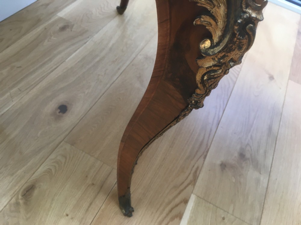 A Louis XV style shaped centre table featuring inlaid coromandel timber, curved cabriole legs, and gilded bronze mounts. View VII