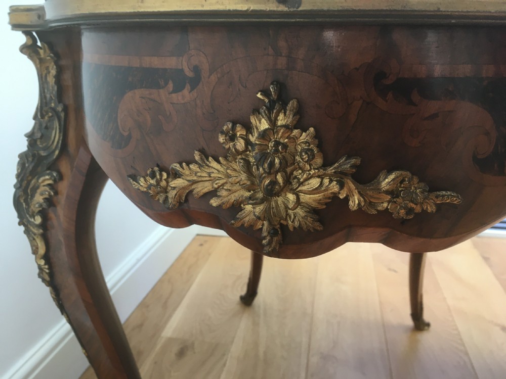 A Louis XV style shaped centre table featuring inlaid coromandel timber, curved cabriole legs, and gilded bronze mounts. View VIII