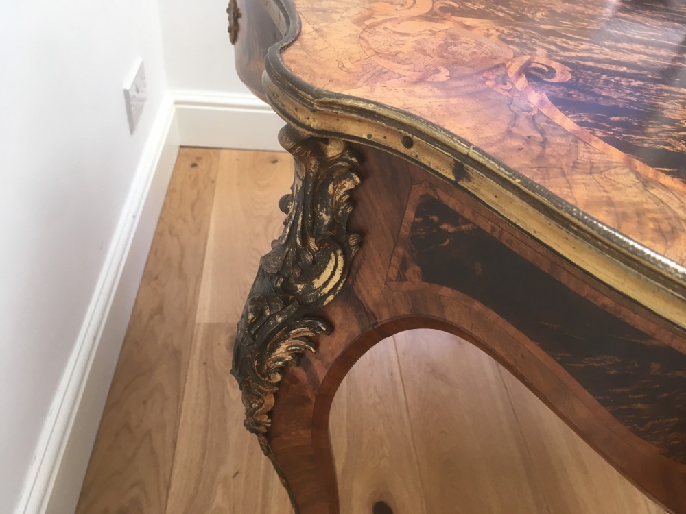 A Louis XV style shaped centre table featuring inlaid coromandel timber, curved cabriole legs, and gilded bronze mounts. View IX