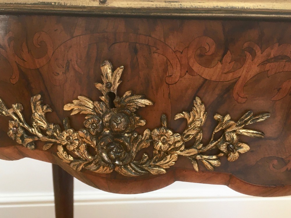 A Louis XV style shaped centre table featuring inlaid coromandel timber, curved cabriole legs, and gilded bronze mounts. View XII