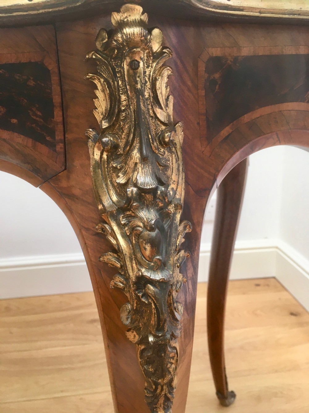 A Louis XV style shaped centre table featuring inlaid coromandel timber, curved cabriole legs, and gilded bronze mounts. View XIII