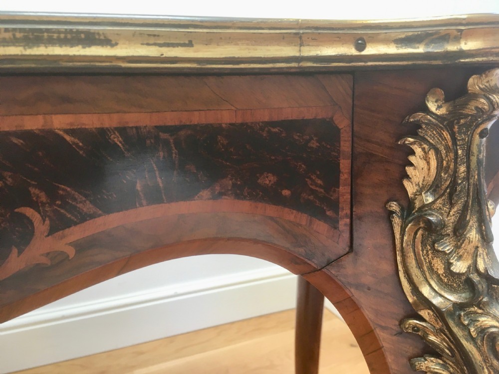 A Louis XV style shaped centre table featuring inlaid coromandel timber, curved cabriole legs, and gilded bronze mounts. View XIV