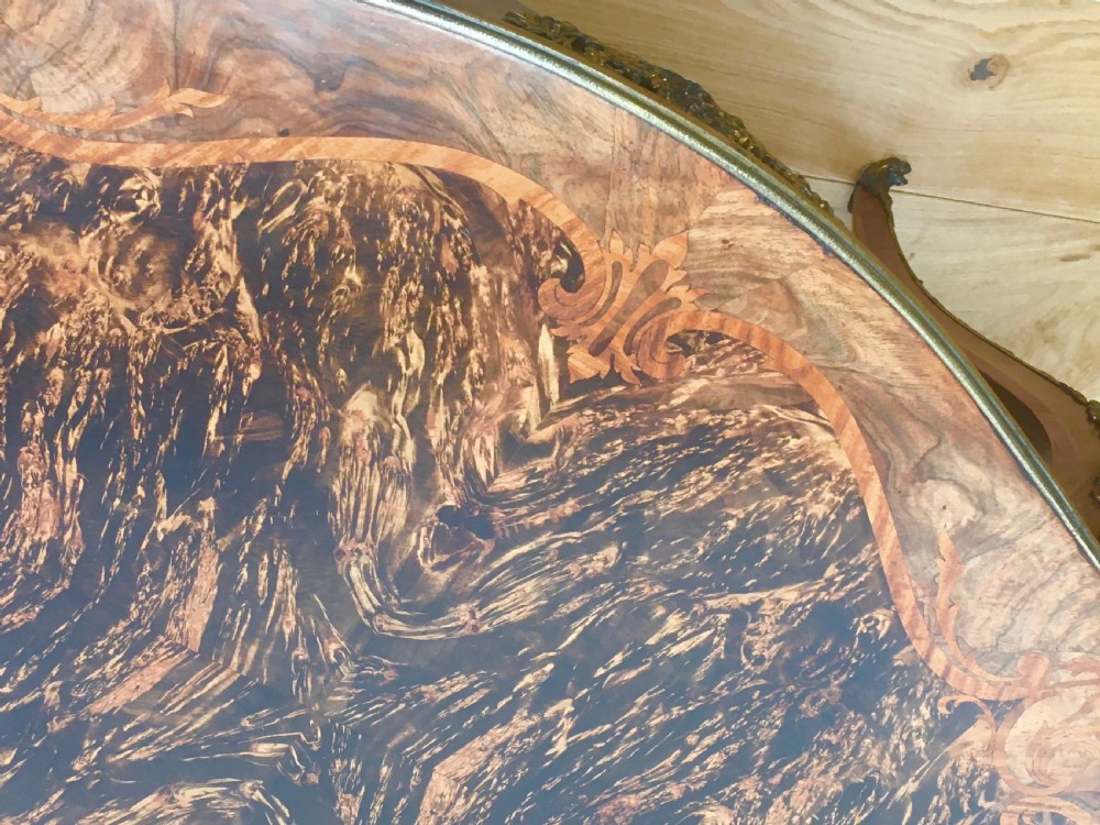 A Louis XV style shaped centre table featuring inlaid coromandel timber, curved cabriole legs, and gilded bronze mounts. View XVII