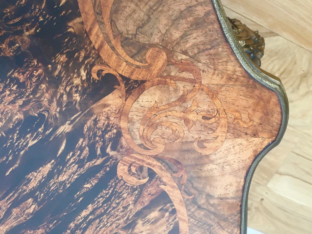 A Louis XV style shaped centre table featuring inlaid coromandel timber, curved cabriole legs, and gilded bronze mounts. View XVIII