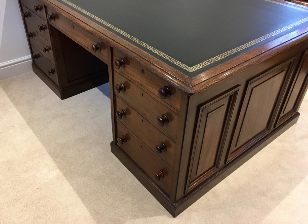 A large mahogany partners desk featuring a dark green gold-tooled leather writing surface and twin pedestals with turned knob handles. View II