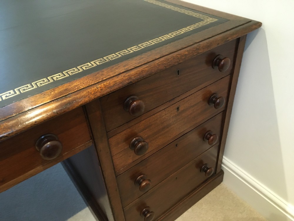 A large mahogany partners desk featuring a dark green gold-tooled leather writing surface and twin pedestals with turned knob handles. View XI