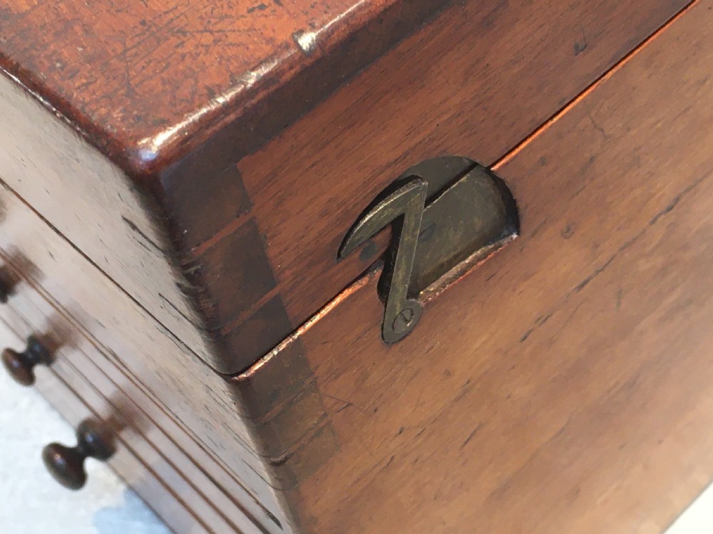 A Victorian mahogany instrument chest featuring a hinged top lid and five graduated drawers lined with dark blue velvet. View V