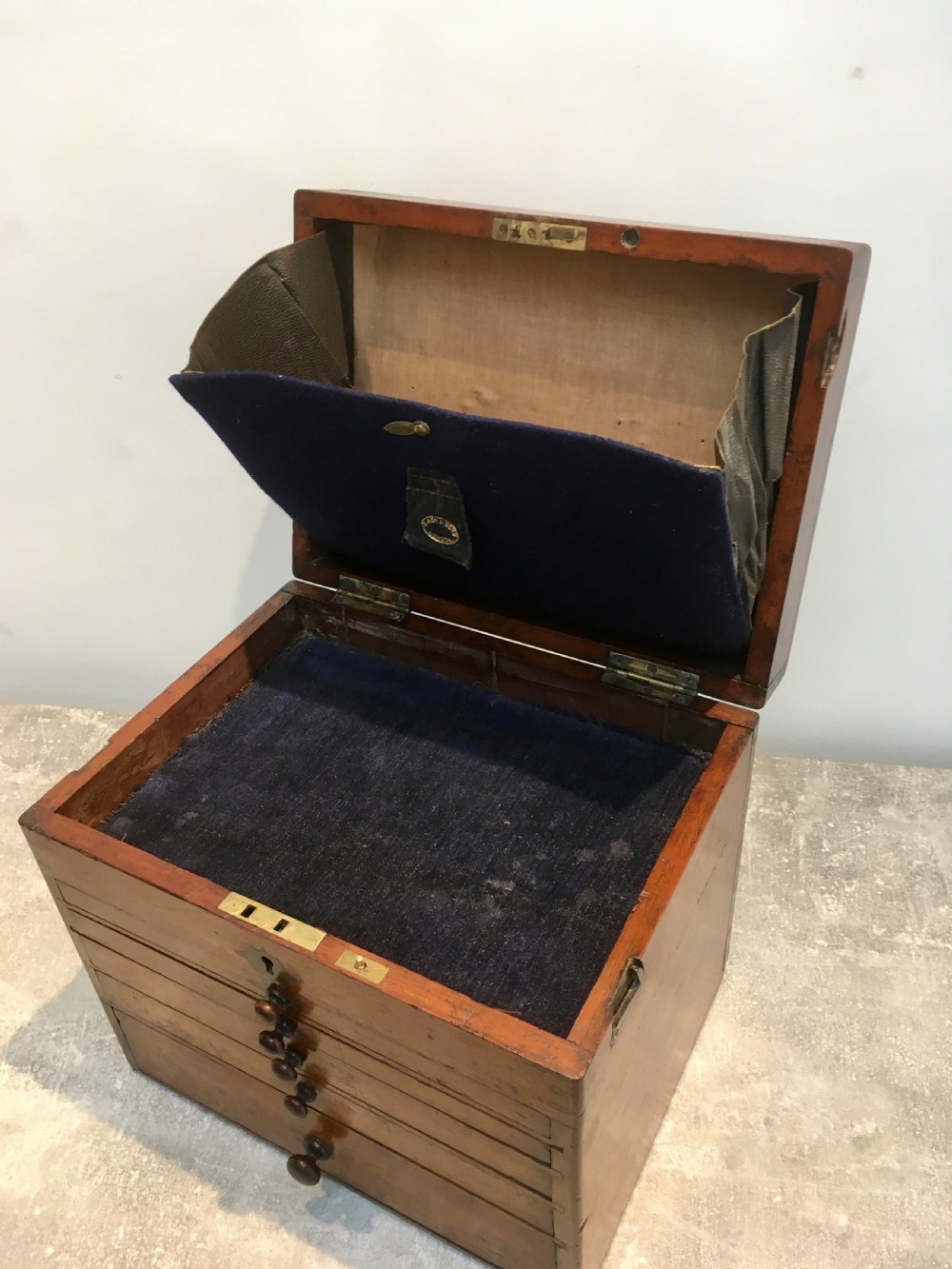A Victorian mahogany instrument chest featuring a hinged top lid and five graduated drawers lined with dark blue velvet. View IX