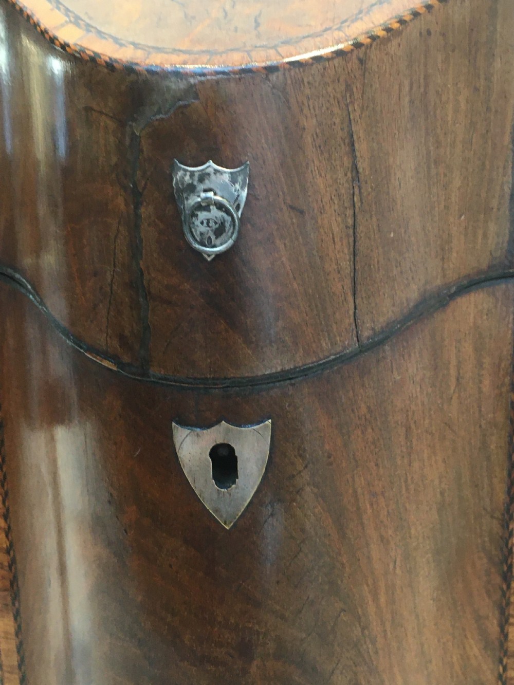 A George III mahogany slanted-top knife box shown open, featuring slotted interior fittings, string inlay, and a star marquetry motif on the inside lid. View VII