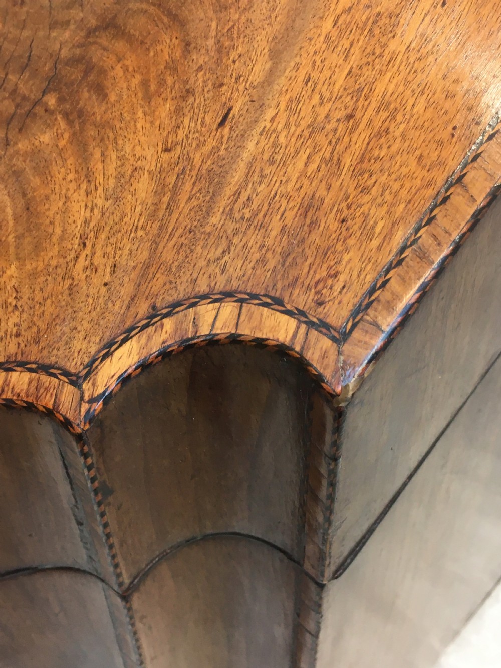 A George III mahogany slanted-top knife box shown open, featuring slotted interior fittings, string inlay, and a star marquetry motif on the inside lid. View VIII