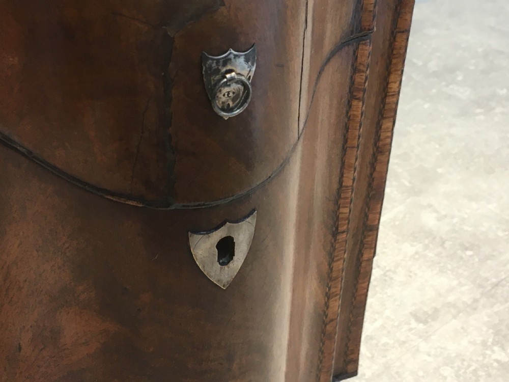 A George III mahogany slanted-top knife box shown open, featuring slotted interior fittings, string inlay, and a star marquetry motif on the inside lid. View XII