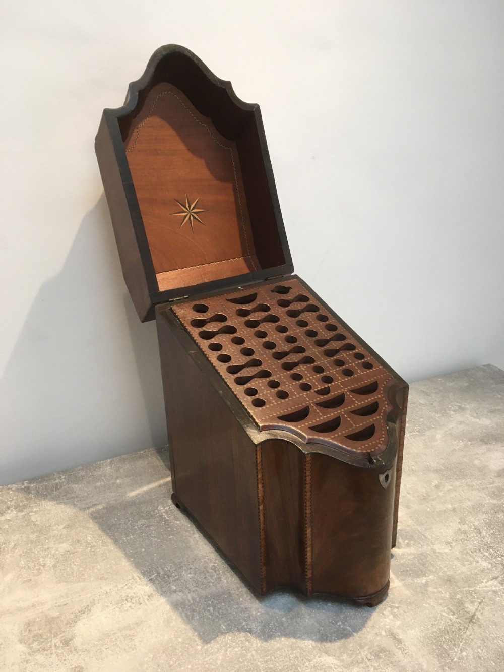 A George III mahogany slanted-top knife box shown open, featuring slotted interior fittings, string inlay, and a star marquetry motif on the inside lid. View XIV