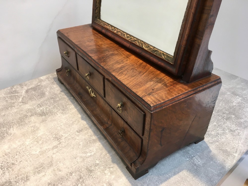 An 18th-century walnut toilet mirror featuring an adjustable rectangular glass frame set above a stepped base with small drawers and brass drop handles. View III
