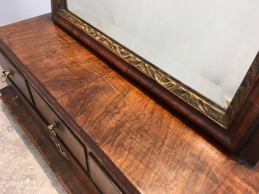 An 18th-century walnut toilet mirror featuring an adjustable rectangular glass frame set above a stepped base with small drawers and brass drop handles. View IX