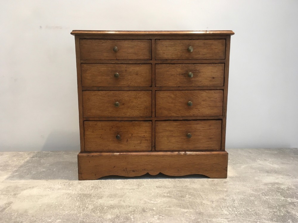 A nineteenth-century medium brown oak collectors chest featuring eight small drawers arranged in two columns with round metal knobs. View III