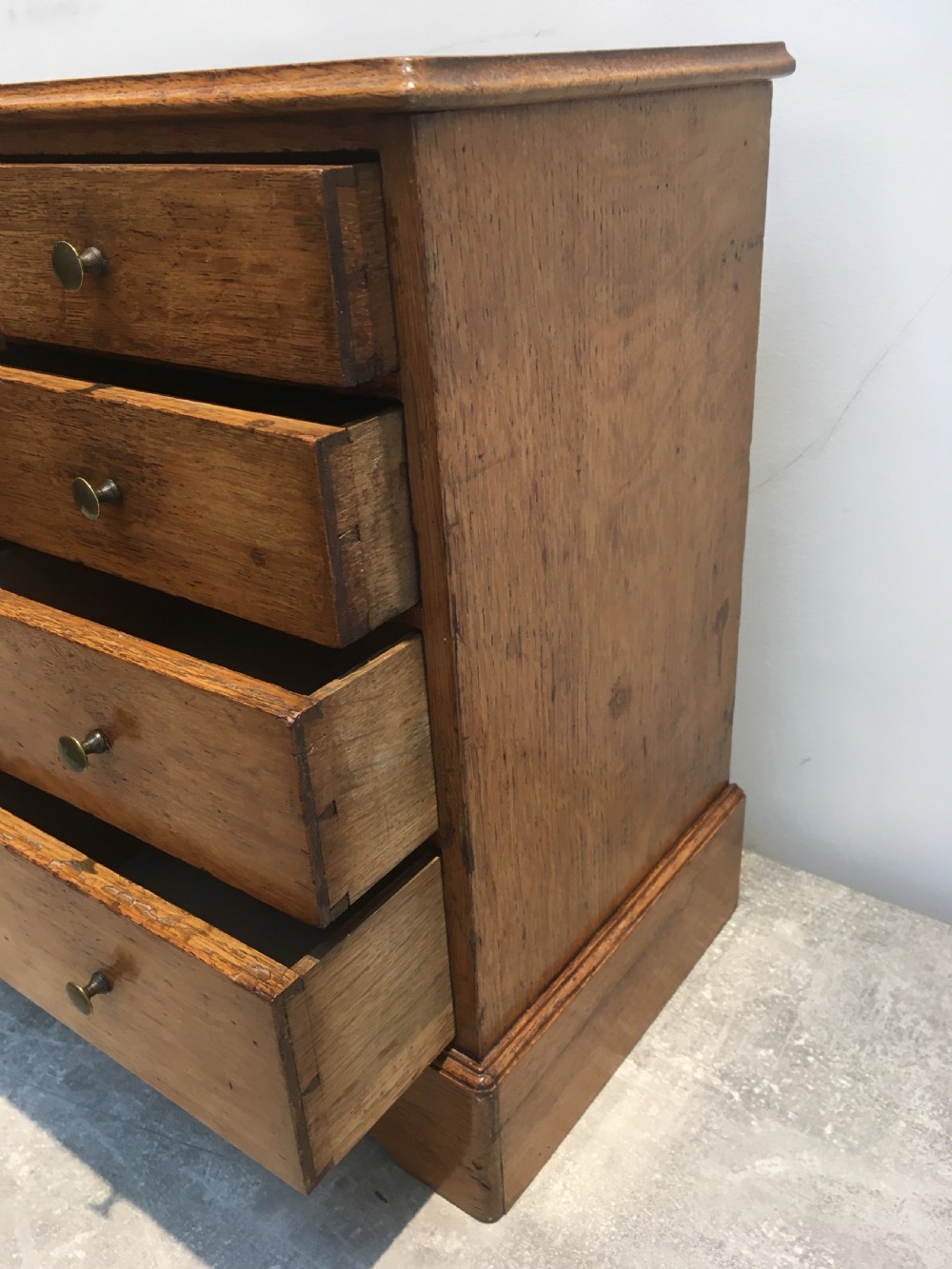 A nineteenth-century medium brown oak collectors chest featuring eight small drawers arranged in two columns with round metal knobs. View VII
