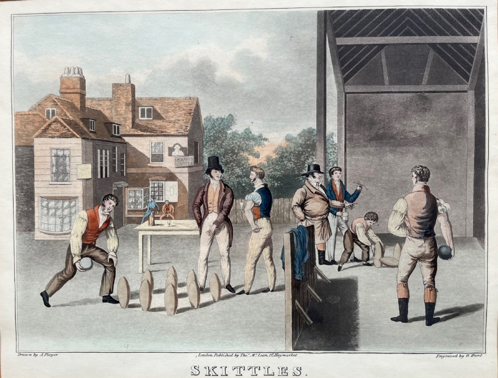 A framed antique hand-coloured engraving depicting gentlemen playing skittles outside an English pub, set within a dark green mount and a warm wood frame. View II