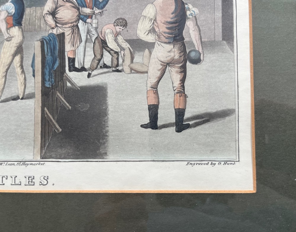 A framed antique hand-coloured engraving depicting gentlemen playing skittles outside an English pub, set within a dark green mount and a warm wood frame. View IV