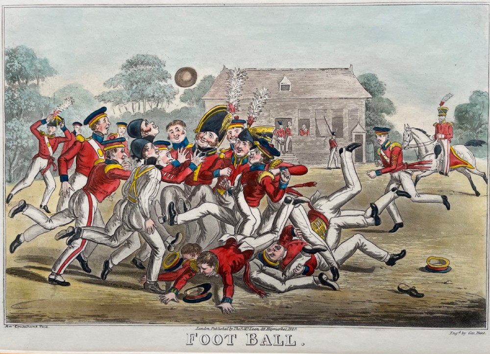 A framed Georgian hand-coloured engraving depicting men in military attire playing football, set within a lined mount and a gilded wooden frame. View II
