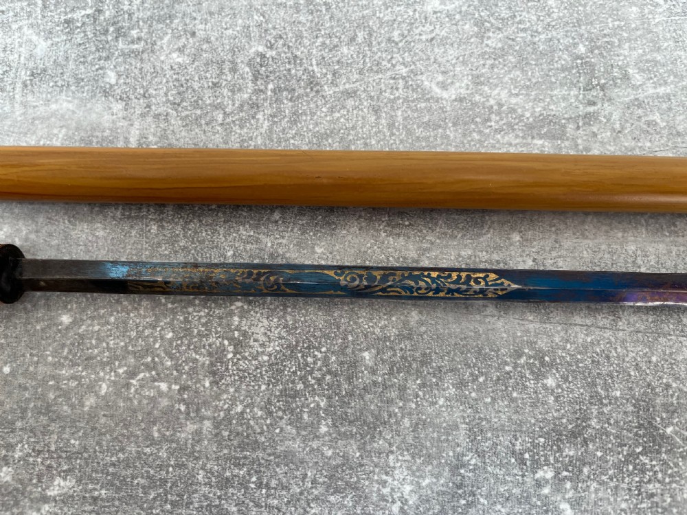 A late Victorian Malacca cane sword stick featuring a silver repousse embossed knop handle and a concealed steel blade alongside its wooden sheath. View VIII