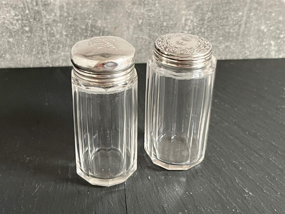 Pair of faceted clear cut glass vanity jars fitted with silver tops featuring engraved and chased detailing. View XI