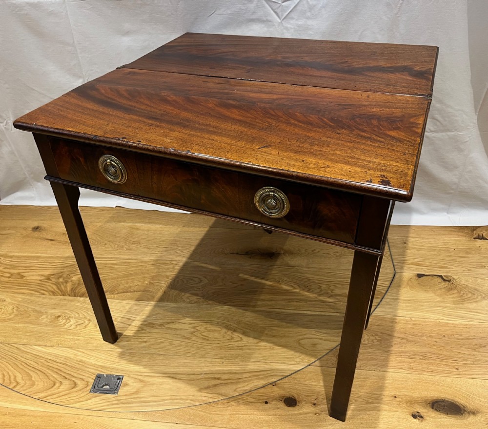 A Regency mahogany fold-over side table featuring tapered square legs, a single drawer with twin circular brass handles, and a hinged timber top. View III