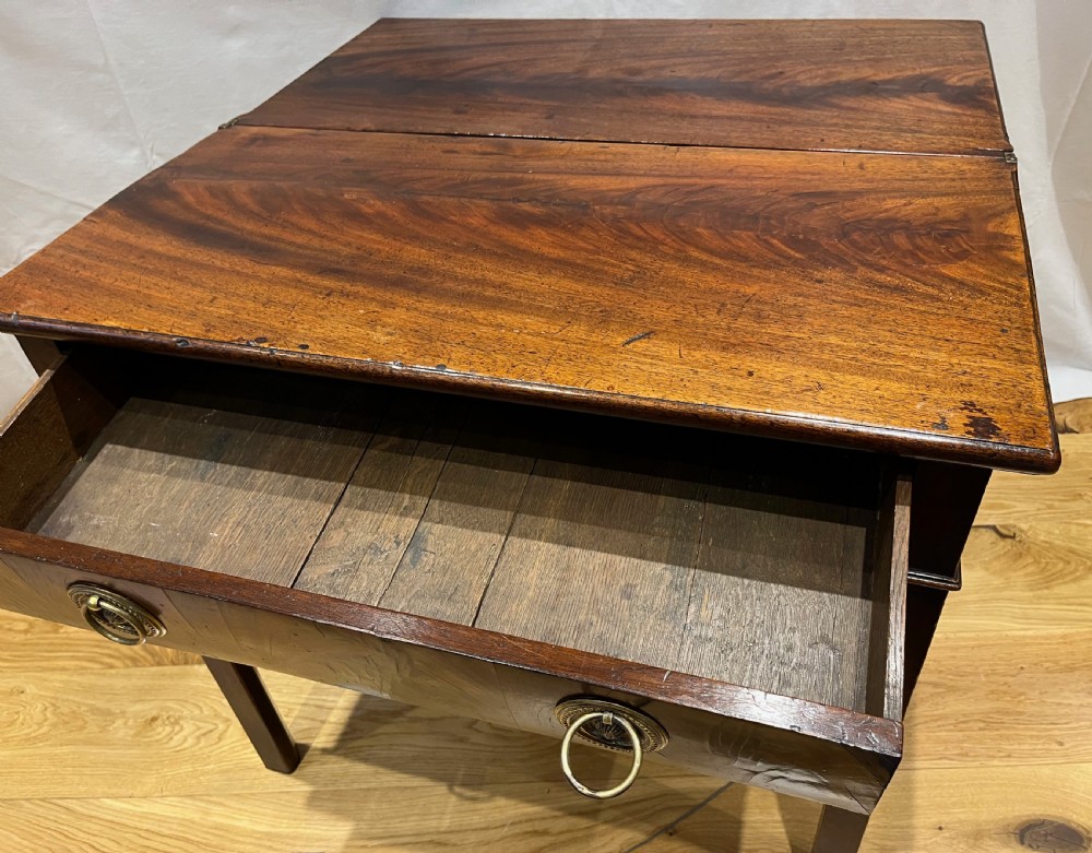 A Regency mahogany fold-over side table featuring tapered square legs, a single drawer with twin circular brass handles, and a hinged timber top. View VII