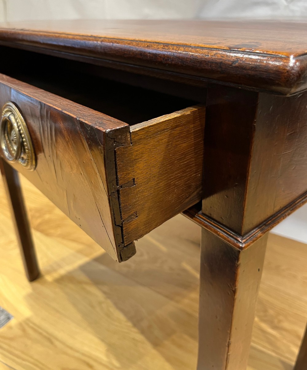 A Regency mahogany fold-over side table featuring tapered square legs, a single drawer with twin circular brass handles, and a hinged timber top. View VIII