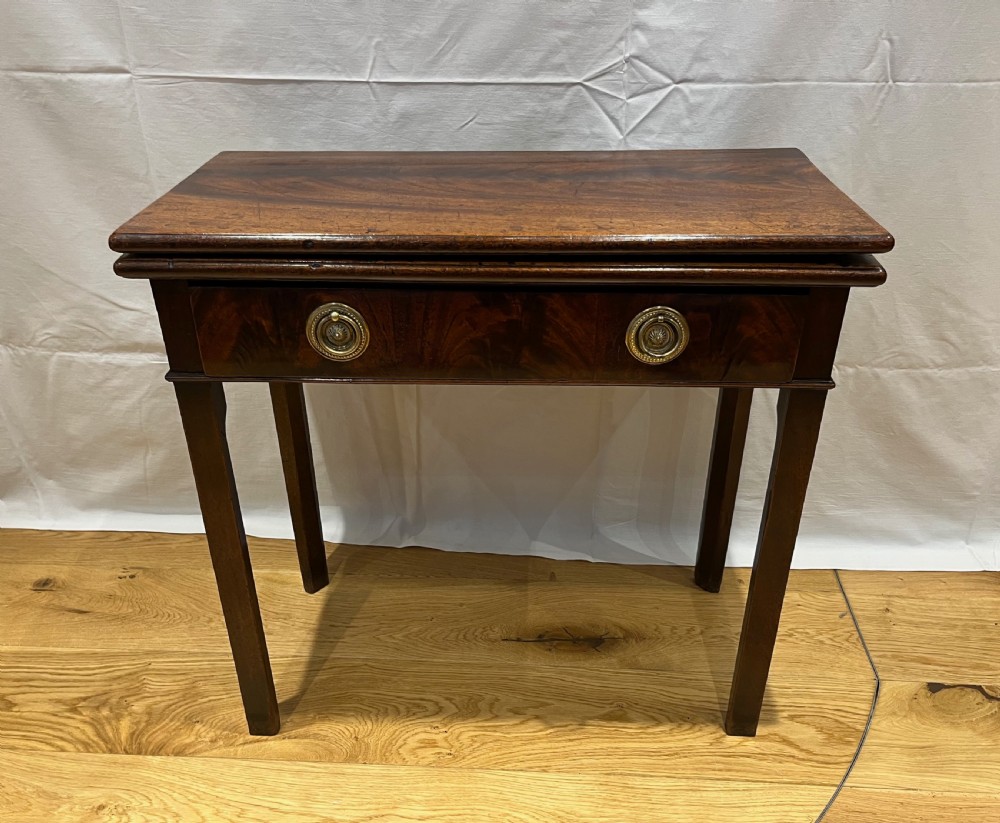 A Regency mahogany fold-over side table featuring tapered square legs, a single drawer with twin circular brass handles, and a hinged timber top. View XII