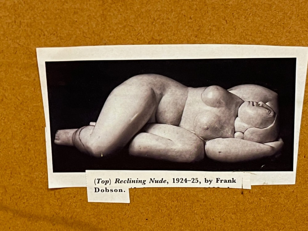 A mid-twentieth-century figure drawing by Frank Dobson depicting a reclining female nude executed in charcoal, white chalk, terracotta, and blue pastel on grey paper. View VII