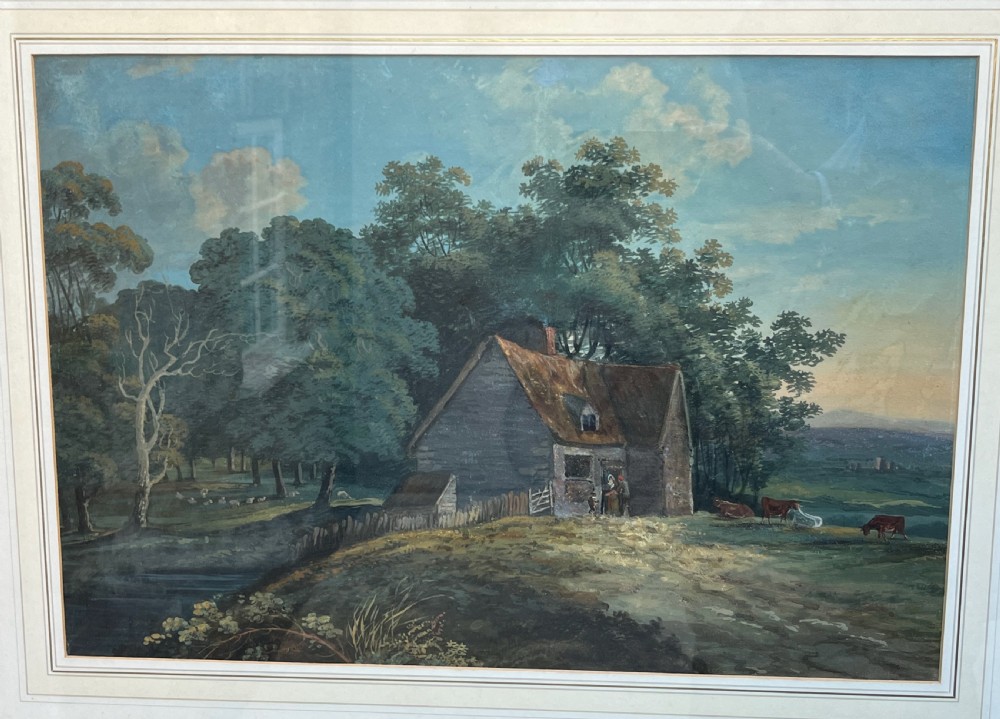A framed 19th-century watercolour painting featuring a rustic cottage nestled among lush trees with livestock in a rolling landscape, presented in a gilt frame. View II