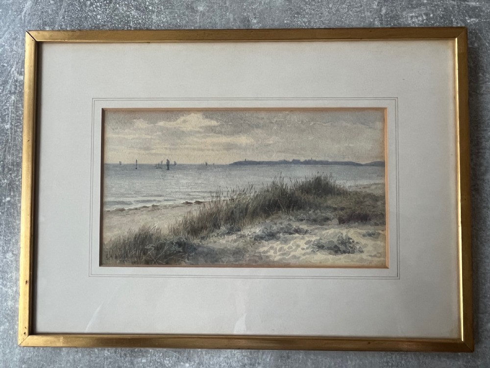 An antique framed watercolour painting depicting sand dunes in the foreground and distant sailboats on a calm sea under an overcast sky. View V