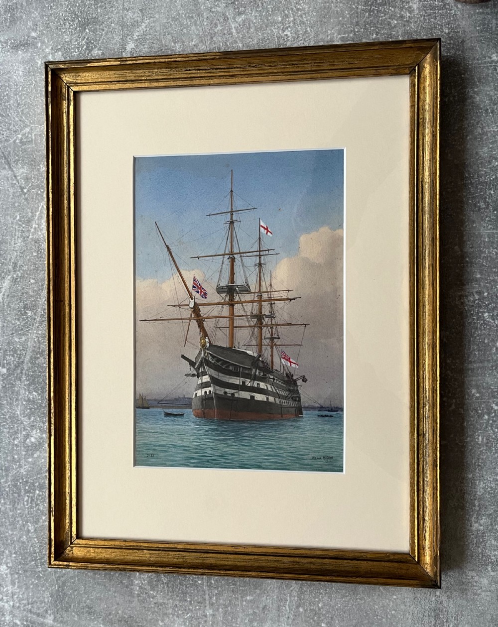 A framed 19th-century watercolour painting depicting the historic naval ship HMS Victory at sea, housed in a giltwood frame with a cream mount. View VI