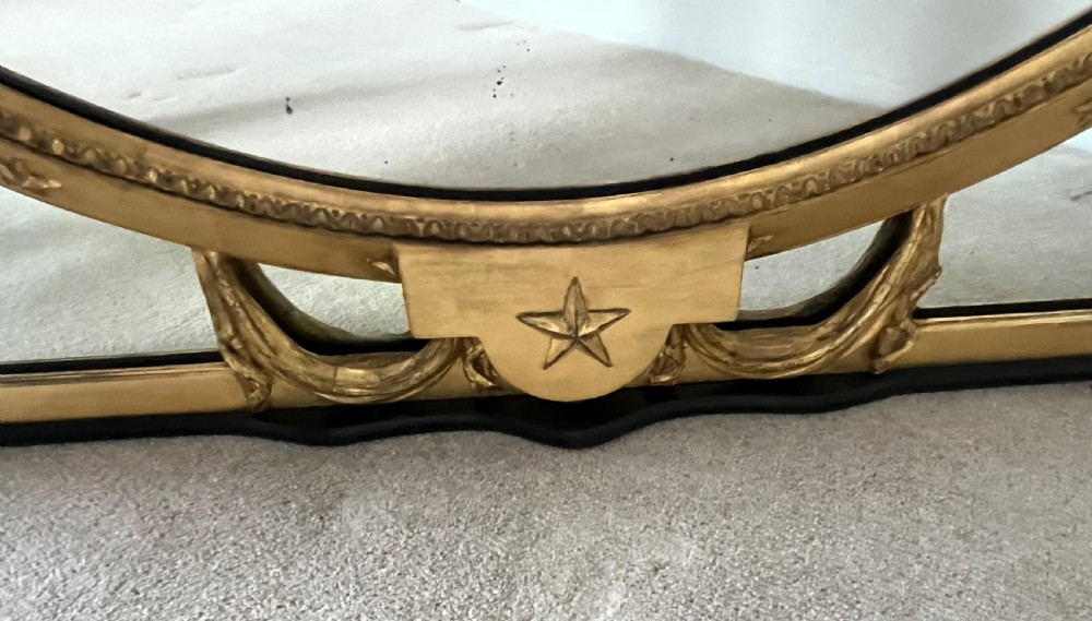 Large Victorian oval overmantel mirror featuring a gilded frame with star motifs, scrollwork base brackets, and an acanthus crest. View V