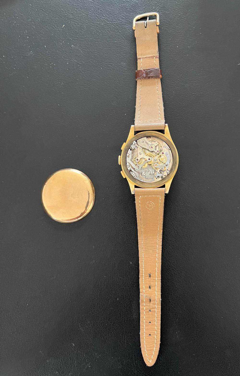 A vintage 18ct gold circular chronograph wristwatch featuring a silvered dial, dual sub-dials, gold hands, and a brown leather strap. View III