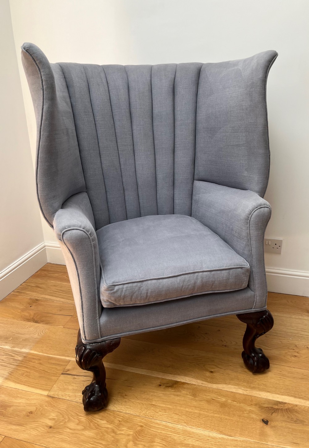 A high-backed Victorian barrel back armchair upholstered in light grey fabric, featuring channel-tufted back detailing and dark carved cabriole legs with ball and claw feet. View II