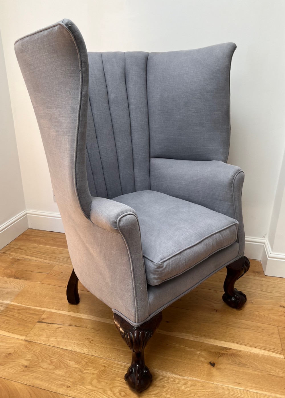 A high-backed Victorian barrel back armchair upholstered in light grey fabric, featuring channel-tufted back detailing and dark carved cabriole legs with ball and claw feet. View III