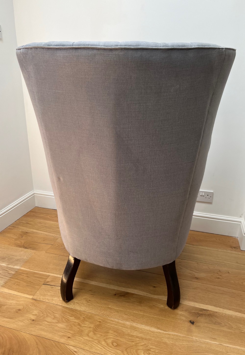 A high-backed Victorian barrel back armchair upholstered in light grey fabric, featuring channel-tufted back detailing and dark carved cabriole legs with ball and claw feet. View V