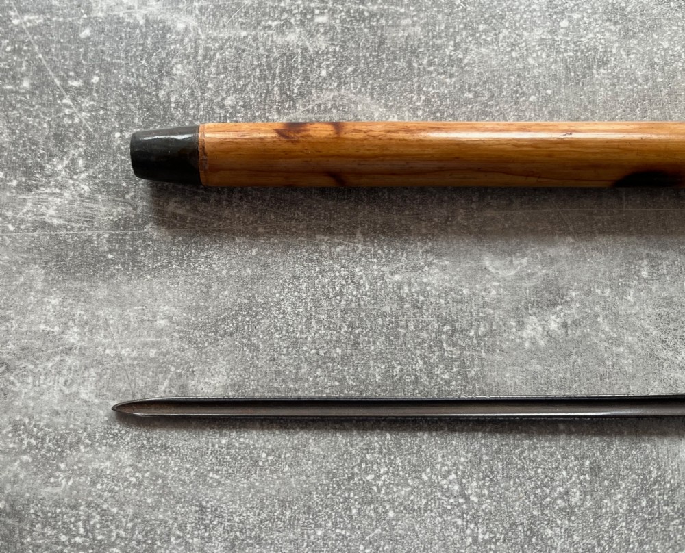 An antique bamboo walking stick shown disassembled to reveal a long steel blade and a dark curved pistol-grip handle with metal ferrules. View VIII