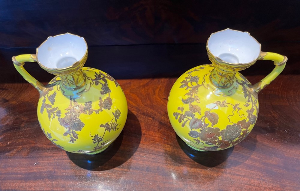 A pair of yellow porcelain ewers with gilded floral decoration, narrow necks, and single handles. View III