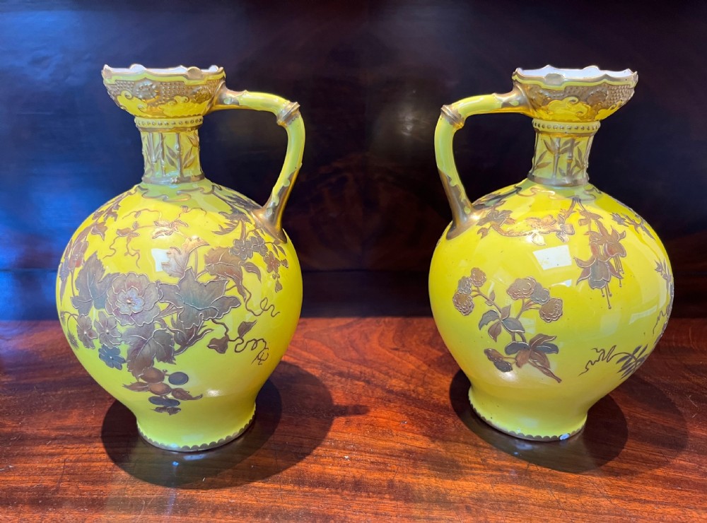 A pair of yellow porcelain ewers with gilded floral decoration, narrow necks, and single handles. View IV