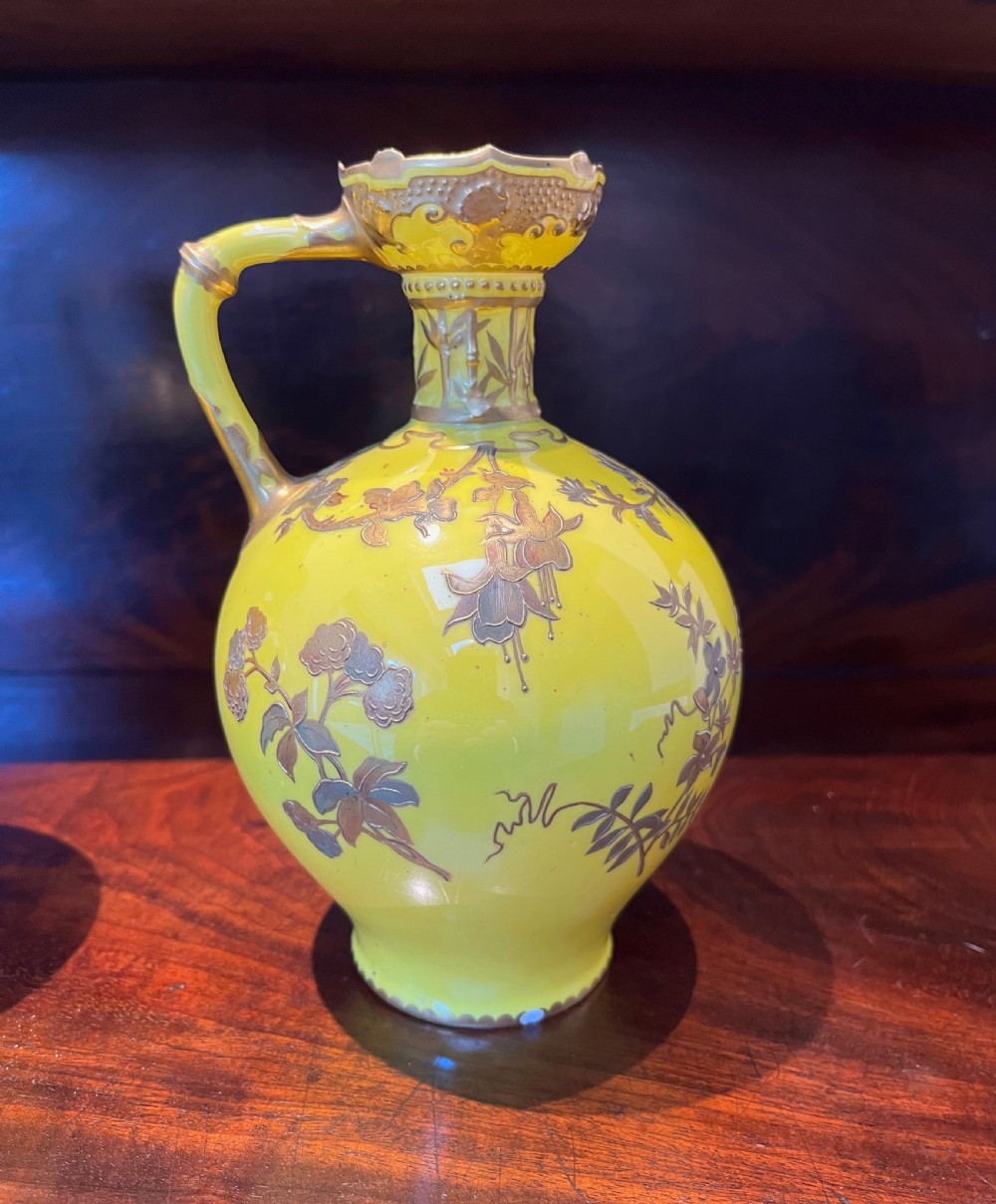 A pair of yellow porcelain ewers with gilded floral decoration, narrow necks, and single handles. View VII