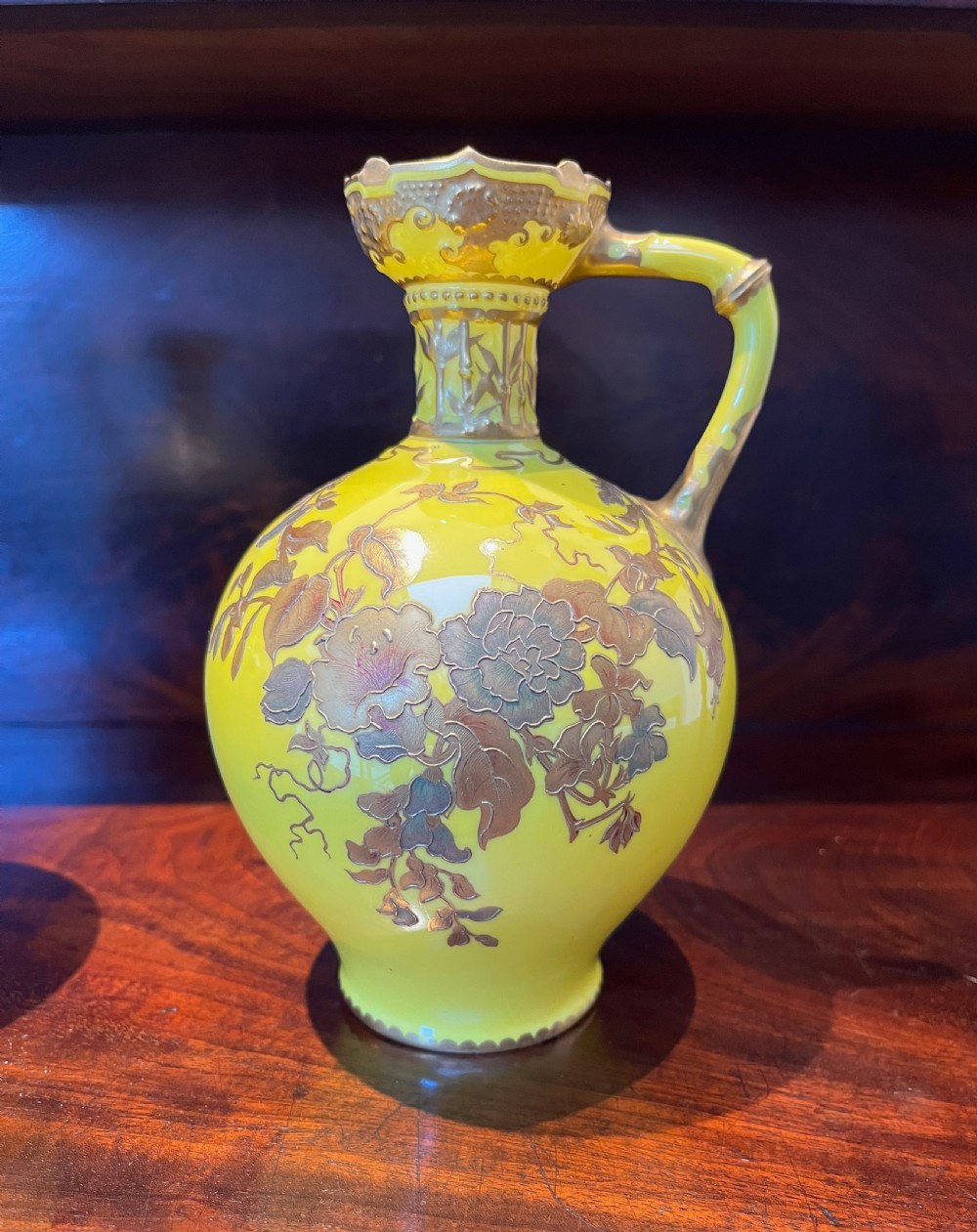 A pair of yellow porcelain ewers with gilded floral decoration, narrow necks, and single handles. View VIII