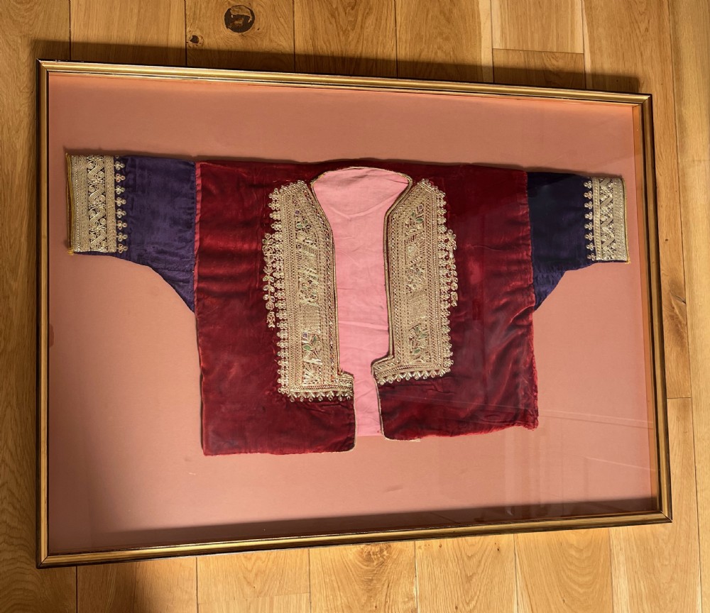 A late 19th-century Ottoman red velvet and purple silk jacket with heavy gold metallic embroidery, presented inside a thin gold wood frame. View III