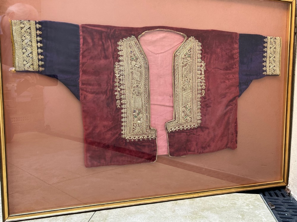 A late 19th-century Ottoman red velvet and purple silk jacket with heavy gold metallic embroidery, presented inside a thin gold wood frame. View V
