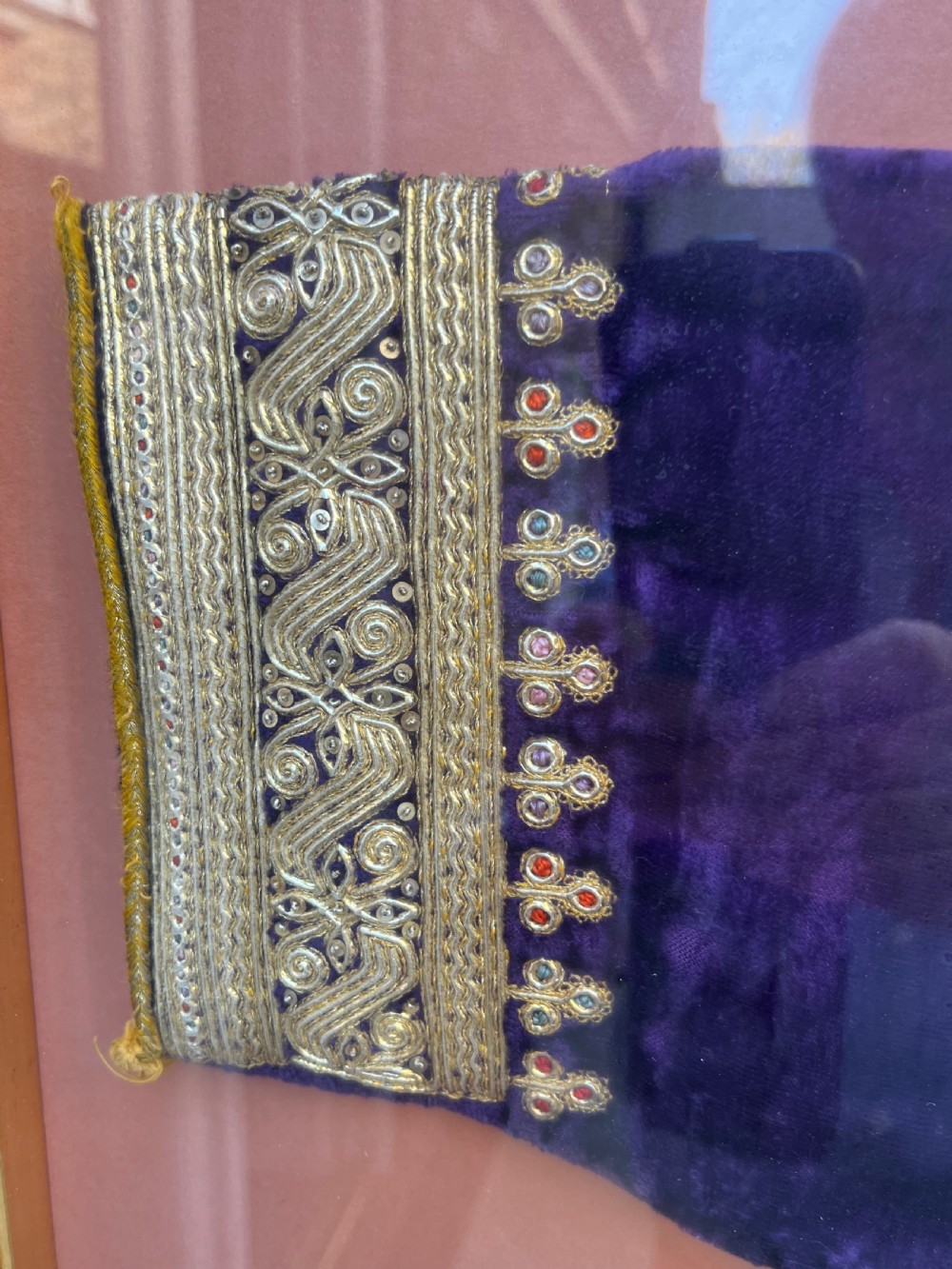 A late 19th-century Ottoman red velvet and purple silk jacket with heavy gold metallic embroidery, presented inside a thin gold wood frame. View VI